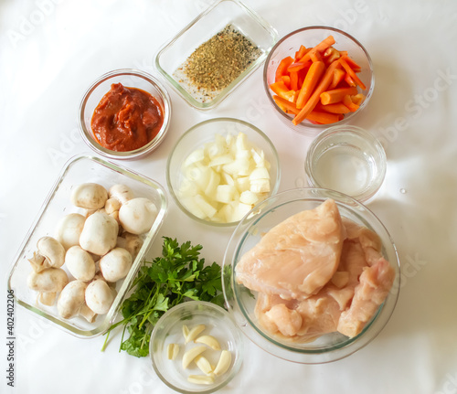Meal preparation ingredients, chicken, mushrooms, vegetables, seasoning, water, tomato sauce