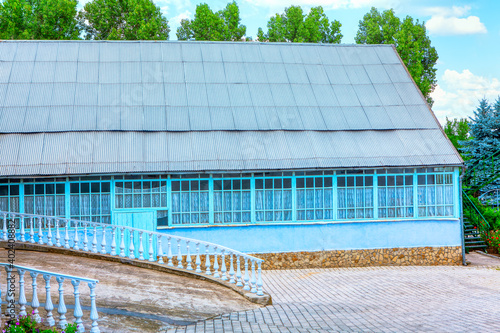 Summer cottage at the church , exterior view . Court of the church with pavement 