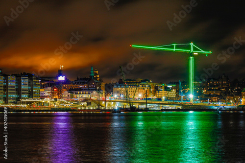 Canvas Print Stockholm, Sweden A large building crane lit in green lights at Slussen