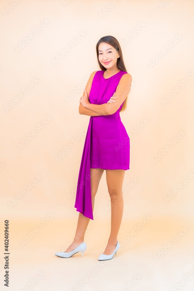 Portrait beautiful young asian woman in action on color background Portrait beautiful young asian woman in action on color background