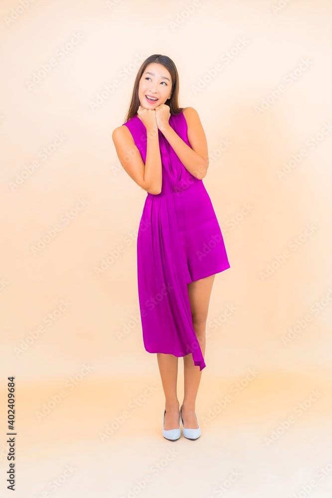 Portrait beautiful young asian woman in action on color background Portrait beautiful young asian woman in action on color background