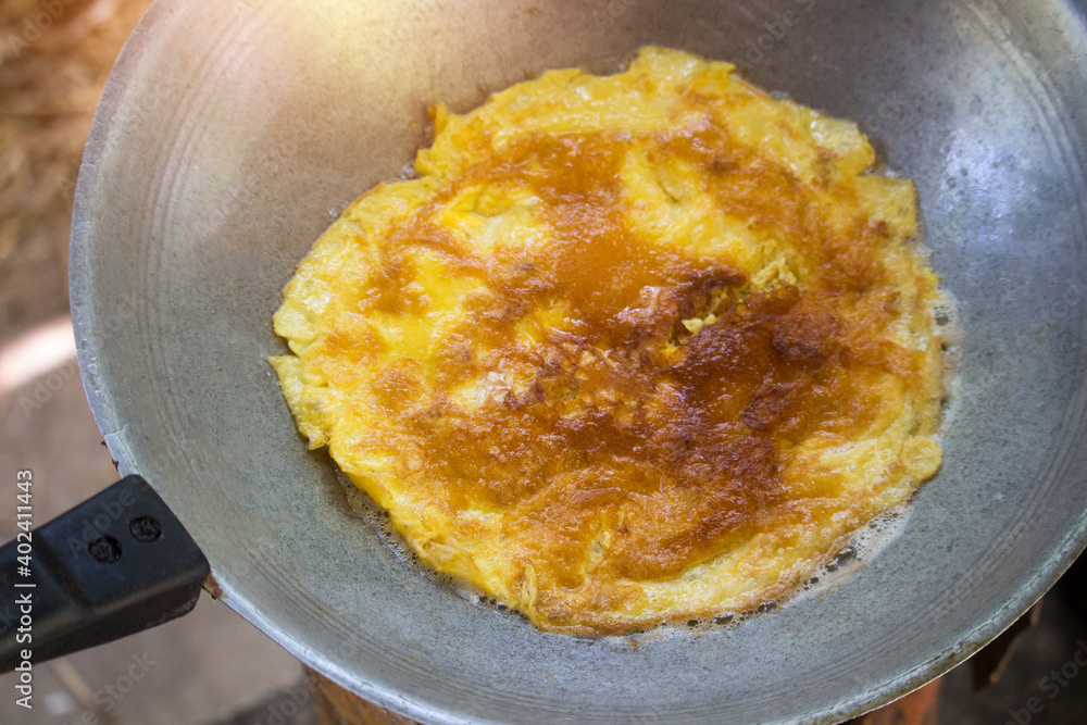 Top view of omelet with minced pork in a pan Top view of omelet with minced pork in a pan
