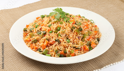 Veg Schezwan Fried Rice Vegetarian Szechuan Rice is indo-chinese cuisine dish with bell peppers, green beans, carrot. 