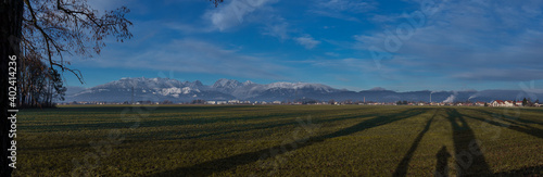 Panorama of Kamnik alps taken from far, from Menges fields in the vicinity of Domzale on a sunny day.