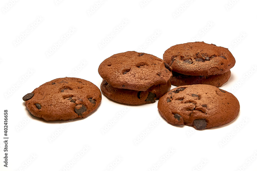 Delicious cookies with cocoa powder and droplets of chocolate icing on white background. Delicious cookies with cocoa powder and droplets of chocolate icing on white background.