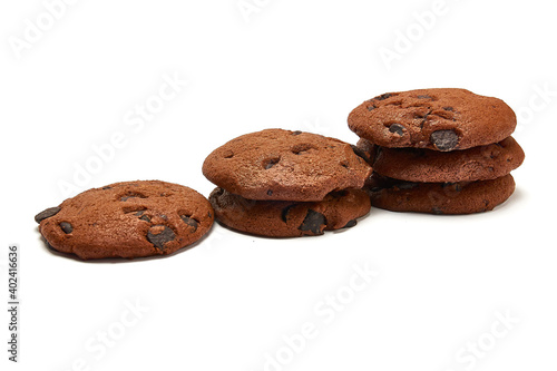 Delicious cookies with cocoa powder and droplets of chocolate icing on white background.