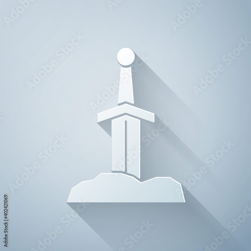 Paper cut Sword in the stone icon isolated on grey background. Excalibur the sword in the stone from the Arthurian legends. Paper art style. Vector.