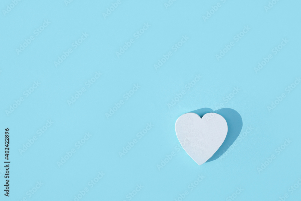 White heart on pastel light blue background. Minimal Valentines day concept.