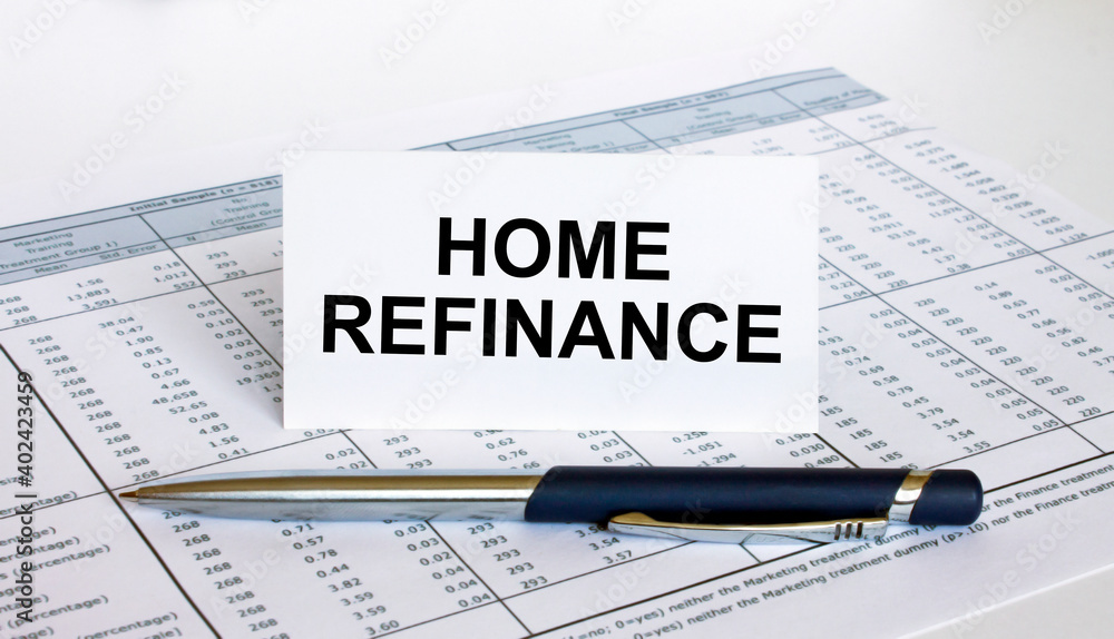 Text Home Refinance on white card with blue metal pen on financial table Text Home Refinance on white card with blue metal pen on financial table
