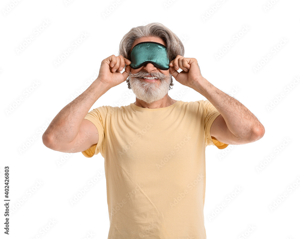 Naklejka premium Mature man in sleep mask on white background