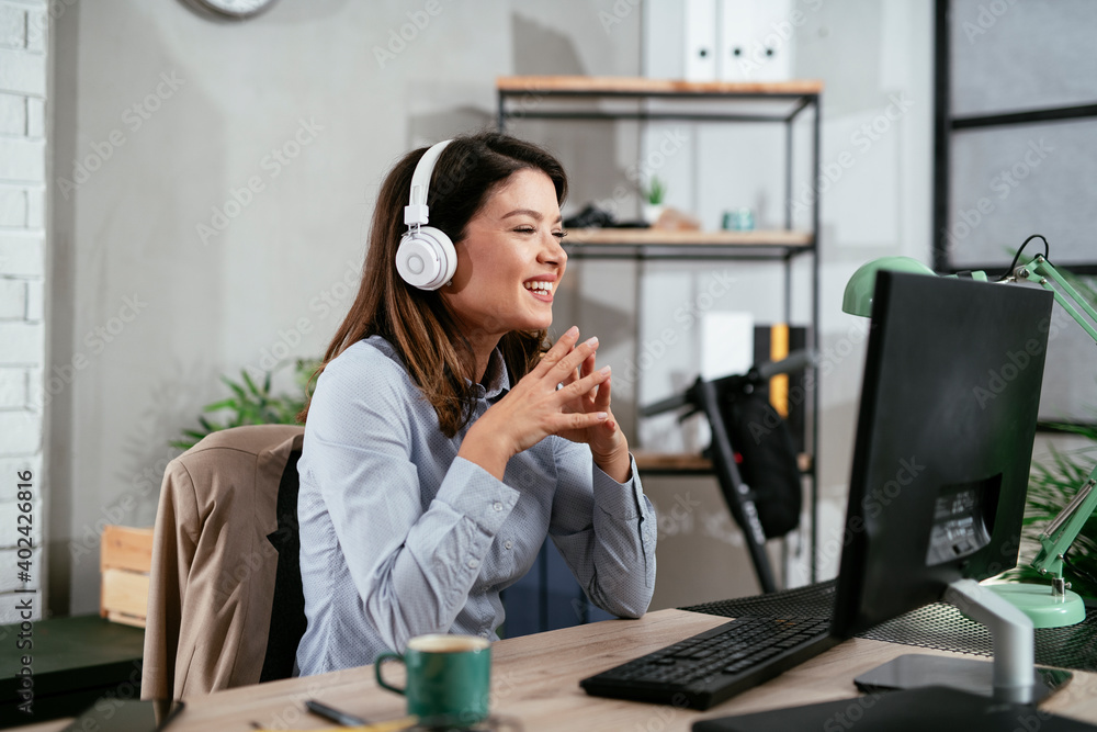 Businesswoman is having a video call on computer. Beautiful woman working in the office. Businesswoman is having a video call on computer. Beautiful woman working in the office.