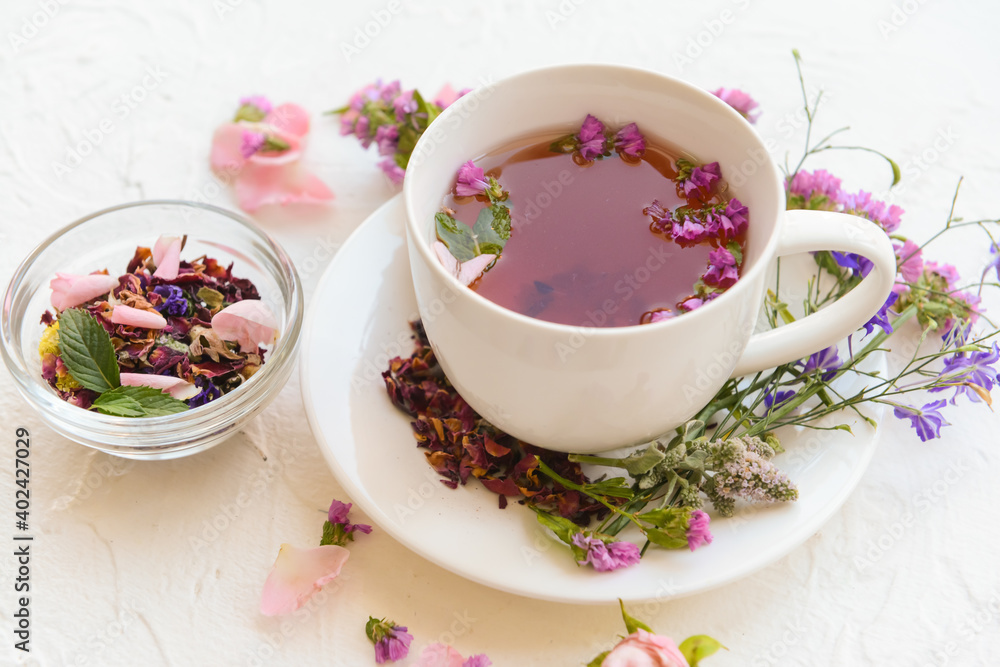 Cup with floral tea on light background Cup with floral tea on light background