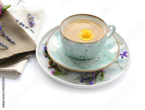 Dry flowers and cup of floral tea on white background