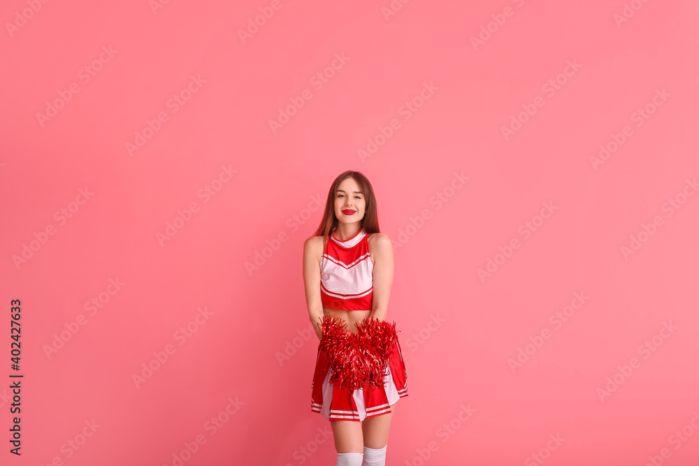 Beautiful young cheerleader on color background Beautiful young cheerleader on color background