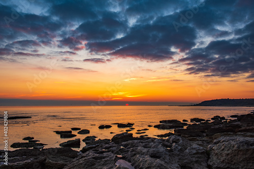 Colorful sunrise on the rocky sea coast