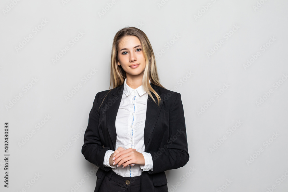 Portrait of young smiling businesswoman standing with hands folded against on white background Portrait of young smiling businesswoman standing with hands folded against on white background