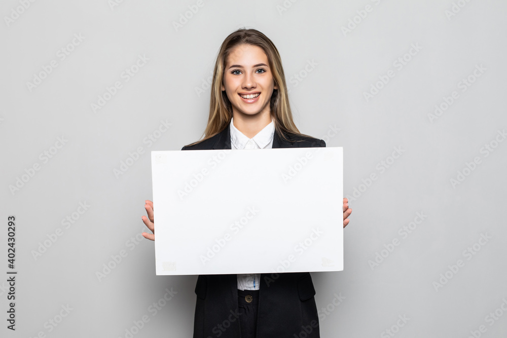 Happy smiling young business woman showing blank signboard on white background Happy smiling young business woman showing blank signboard on white background
