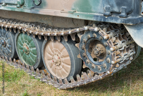 Military tank track system (tank tread, continuous track, chain track) with road wheels in a row and drive sprocket
