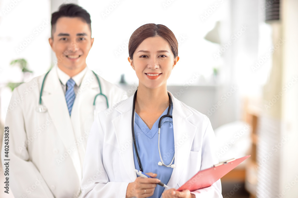 Fototapeta premium two doctors smiling and standing in Hospital