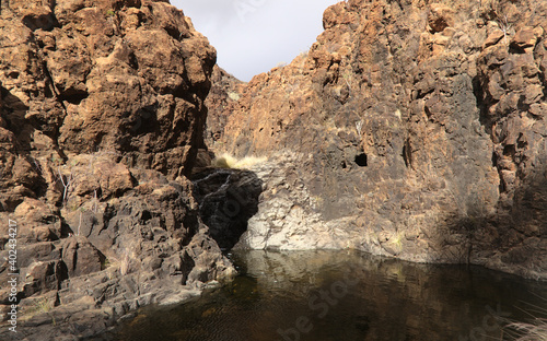 Gran Canaria  landscapes along the hiking route around the ravive Barranco del Toro at the southern part of the  island  full of caves and grottoes  close to San Agustin resort  water is running in th