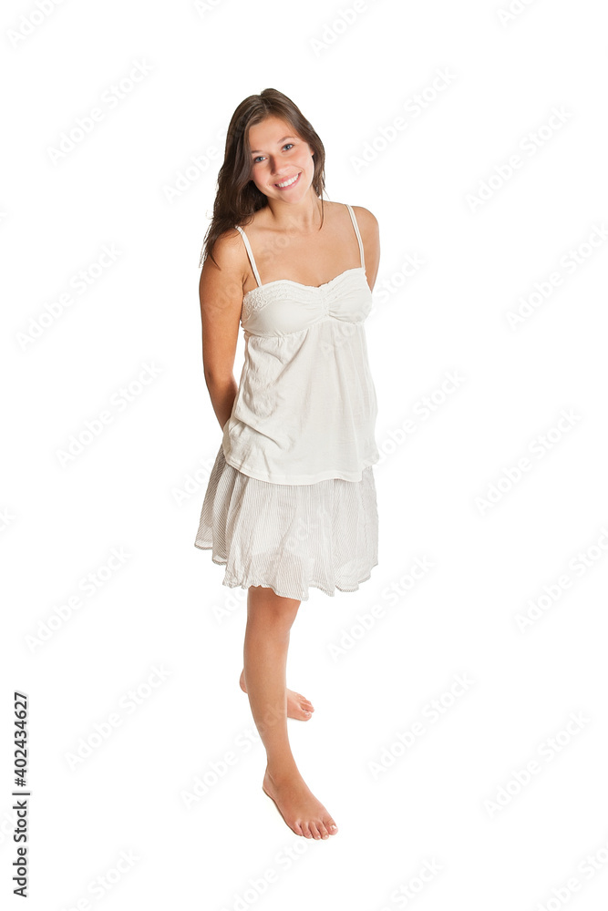 Naklejka premium Full length portrait of a beautiful young woman wearing a white top and a short summer skirt, isolated on white studio background