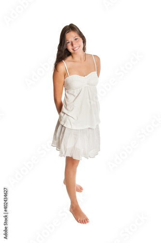 Full length portrait of a beautiful young woman wearing a white top and a short summer skirt, isolated on white studio background © Jochen Schönfeld