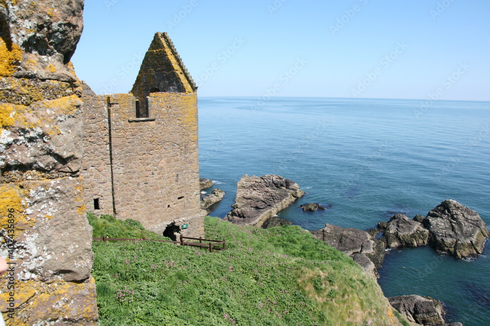Beautiful green coastline with old structures on the scottish coastline Beautiful green coastline with old structures on the scottish coastline