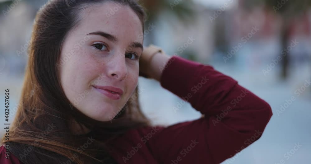 Close-up face of charming young carefree woman with lovely hair and freckles smiling at camera outdoors. Female beauty. Portraits. Close-up face of charming young carefree woman with lovely hair and freckles smiling at camera outdoors. Female beauty. Portraits.