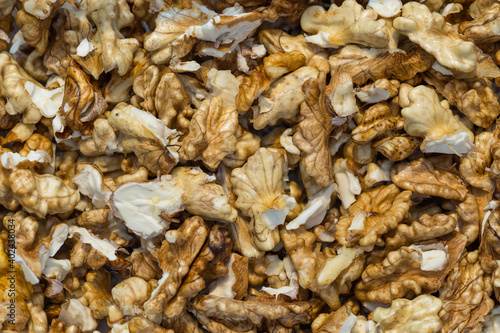 Full frame of peeled raw organic walnuts kernel top view