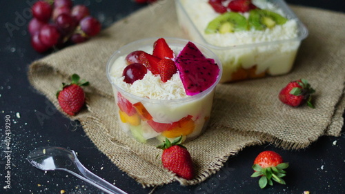 Fruit Salad. healthy food mayonnaise sweet cheese strawberry grape citrus kiwi melon milk yogurt background