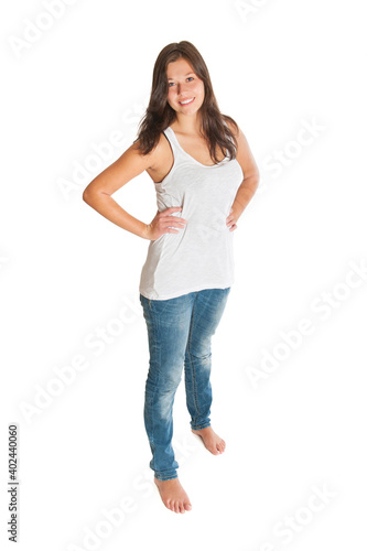 Full length portrait of a gorgeous smiling woman wearing blue jeans and white top, isolated on white studio background