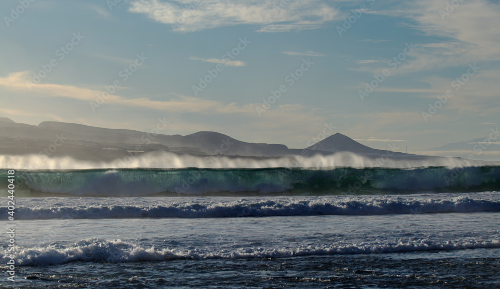 Powerful foamy ocean waves waves are breaking along Las Canteras and El Confital town beaches in Las Palmas de Gran Canaria
