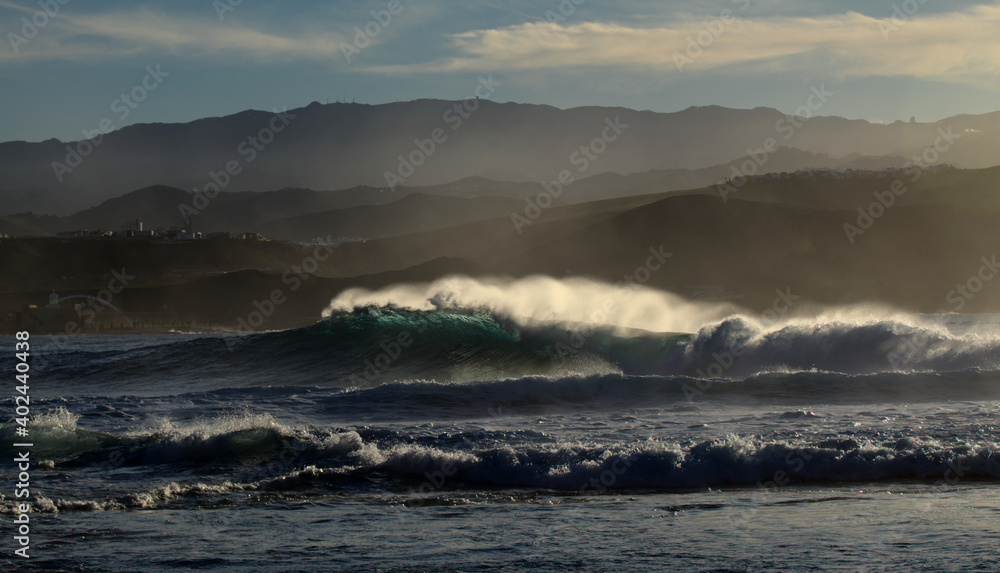 Powerful foamy ocean waves waves are breaking along Las Canteras and El Confital town beaches in Las Palmas de Gran Canaria