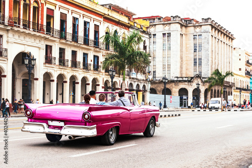 rear view of a family driving in a old convertible car on the streets of havana © Michael Barkmann