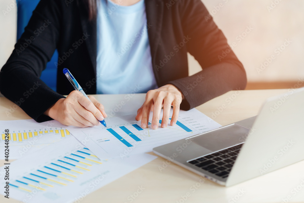 Bussiness woman and report of analysis company in hand with computer notebook on table. Bussiness woman and report of analysis company in hand with computer notebook on table.