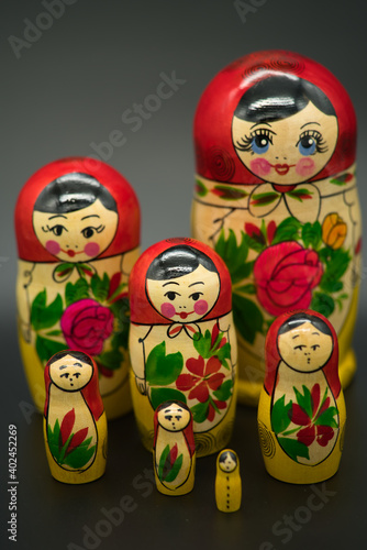 a set of seven matrioshka dolls isolated on dark background © AdobeTim82