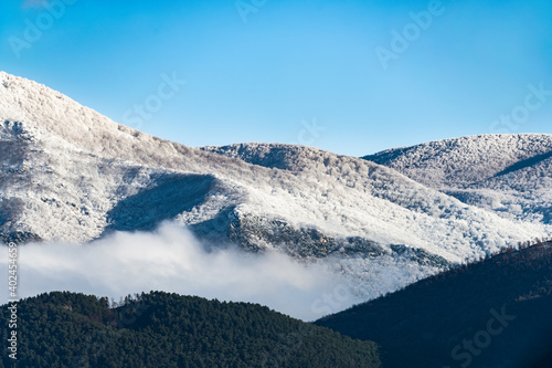Stunning view of a snow capped mountain range during a beautiful sunny day in Italy.