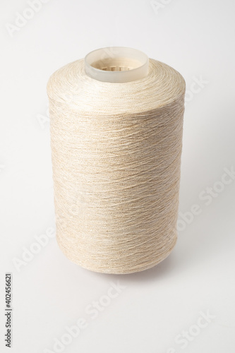bobbin of yarn on a white background. Side view.Textile reel on isolated white back.