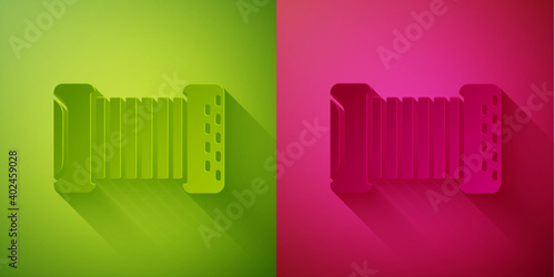 Paper cut Musical instrument accordion icon isolated on green and pink background. Classical bayan, harmonic. Paper art style. Vector.