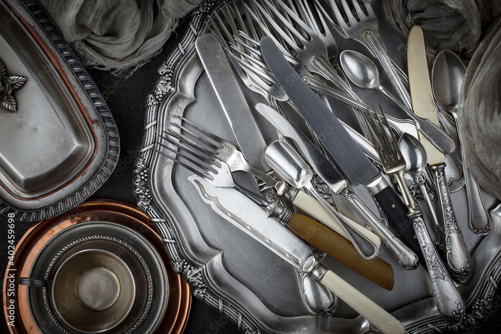 Silver dishes on old background Silver dishes on old background