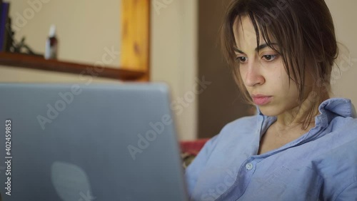 worried concerned woman working on laptop computer looking screen thinking solving problem at home office, serious woman search for inspiration make decision feel lack of ideas, close up view photo