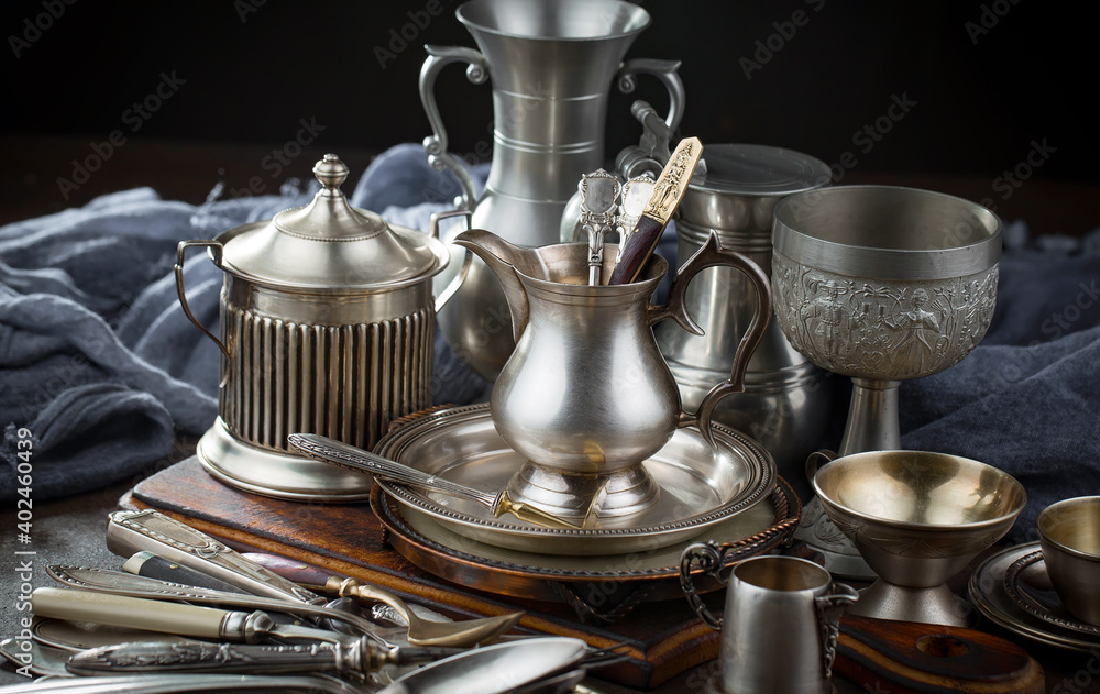 Silver dishes on old background Silver dishes on old background