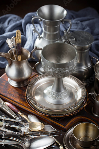 Silver dishes on old background