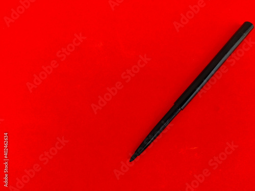 Copy space of Kajal pencil isolated on red background. photo