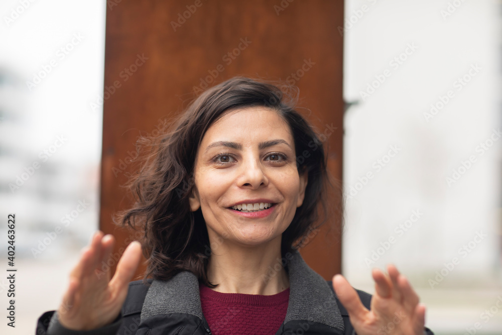 Frau  mit offenen dunklen Haaren außen  und lachend