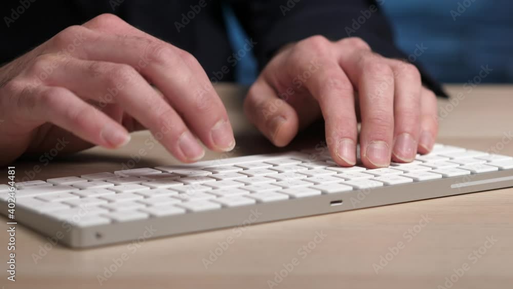 Hands typing on a modern wireless computer keyboard. Hands typing on a modern wireless computer keyboard.