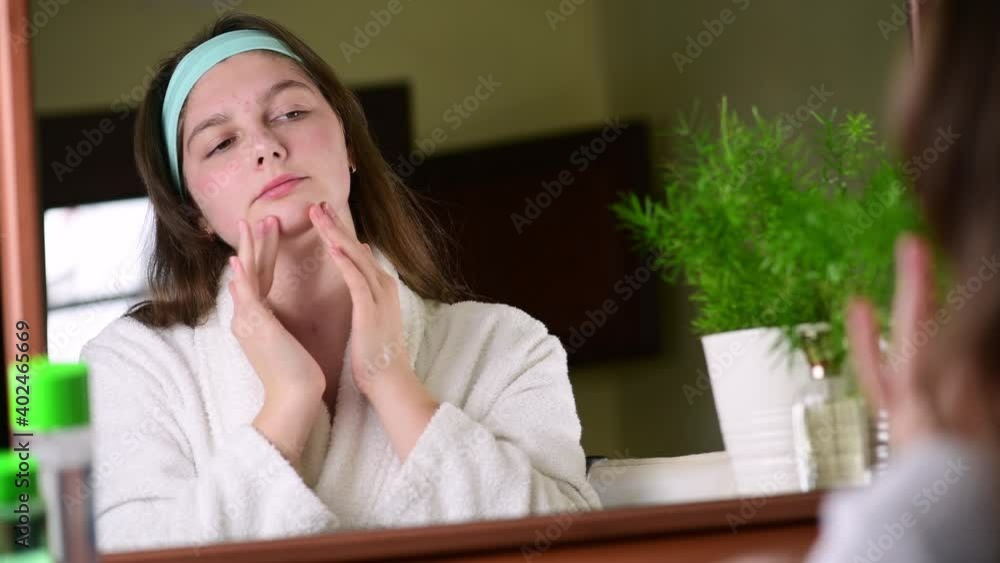 4k Happy attractive young woman making face massage, morning beauty routine, looking in mirror enjoy natural beauty 4k Happy attractive young woman making face massage, morning beauty routine, looking in mirror enjoy natural beauty