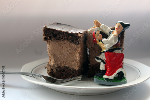 Rigo Jancsi, a traditional Hungarian cube-shaped chocolate sponge cake homemade in Romania with traditional Romanian Clothes photo