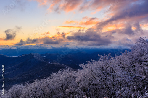 Devil's Knob Overlook - Blue Ridge Mountains ice covered trees and pink and yellow clouds at sunset