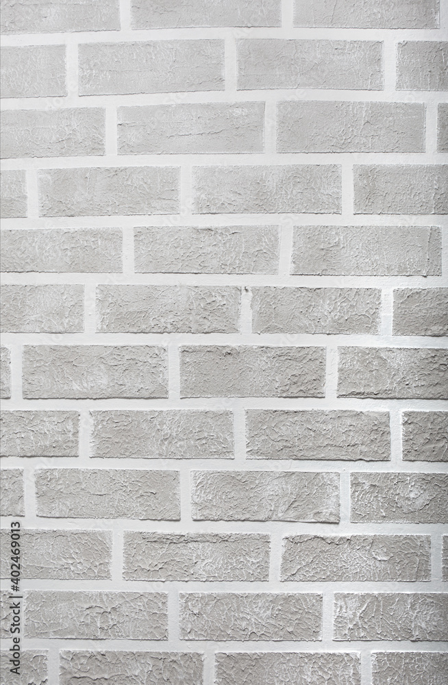 Fototapeta premium Grey brick wall imitation texture. White and beige plaster background.